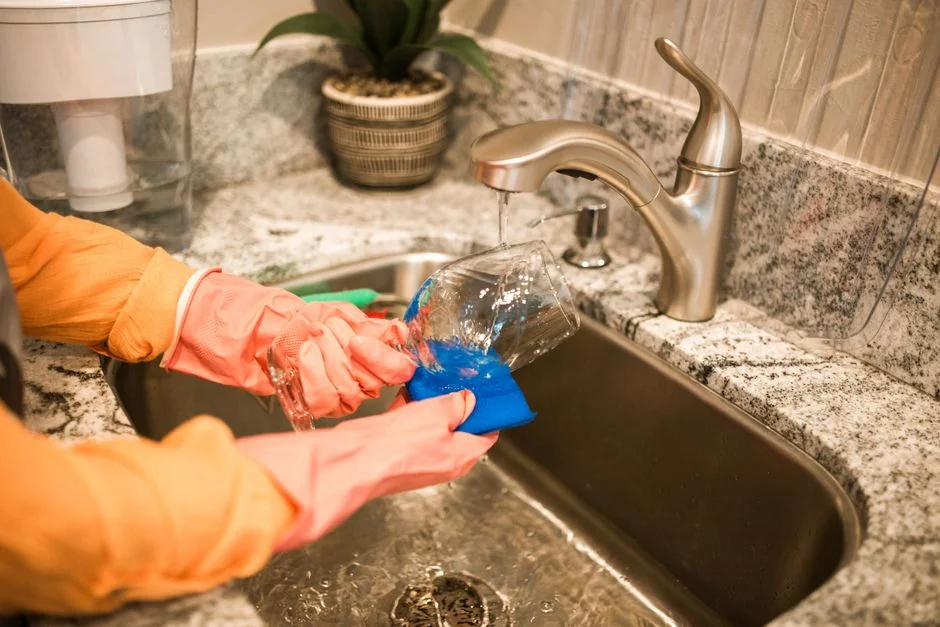 Asian couple having fun while cleaning their home, enhancing a cheerful atmosphere.